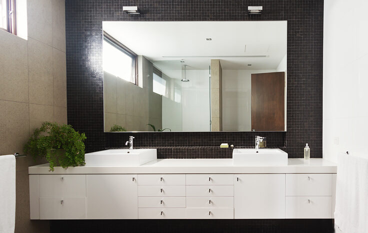 Double basin vanity and mirror in contemporary new large bathroom.