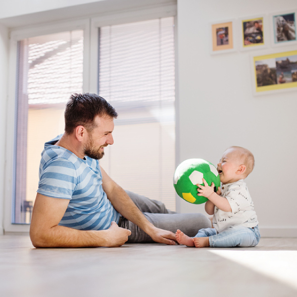 Father and baby son playing on the floor